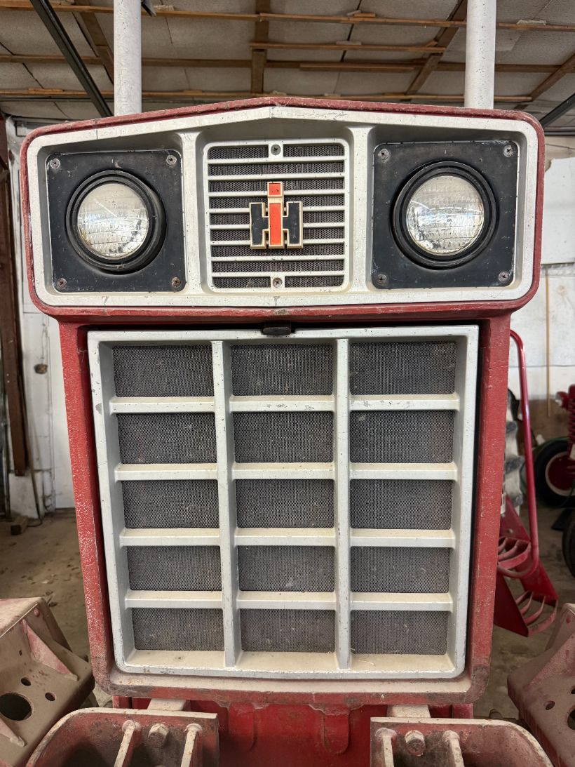 Restored cream and red IH tractor grille with dual headlamps