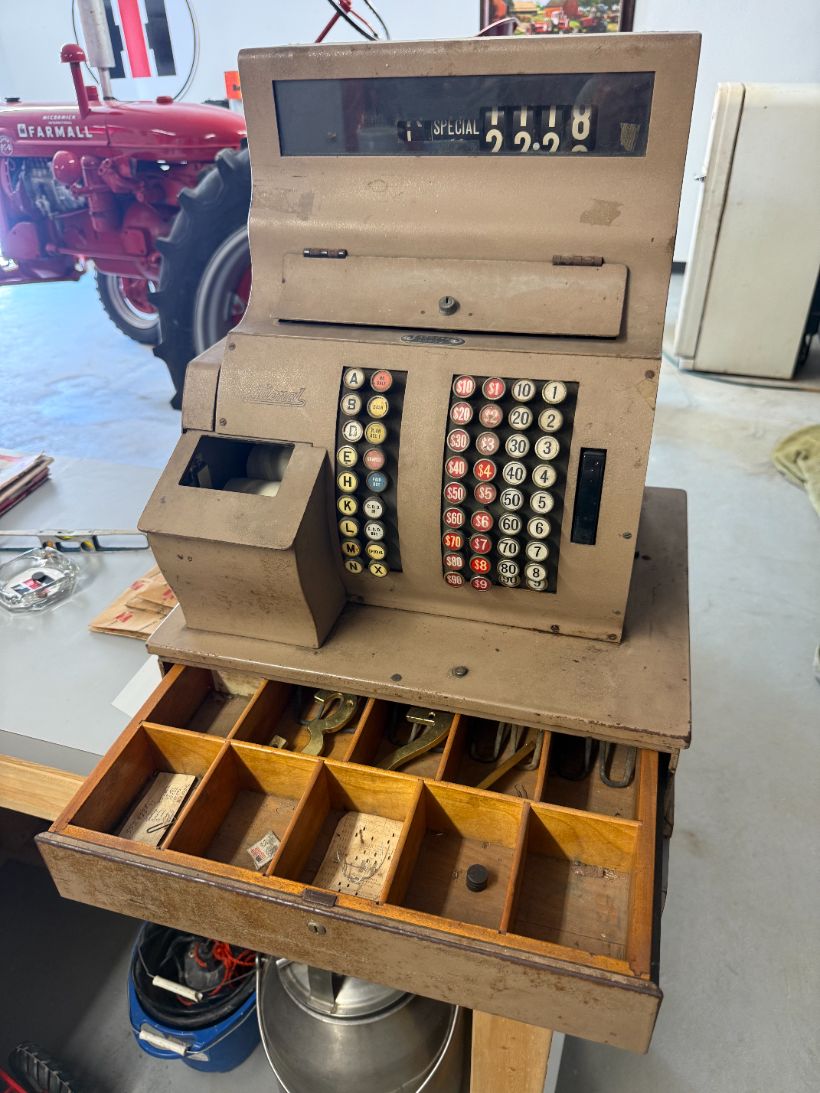 Vintage National brass cash register with its drawer open