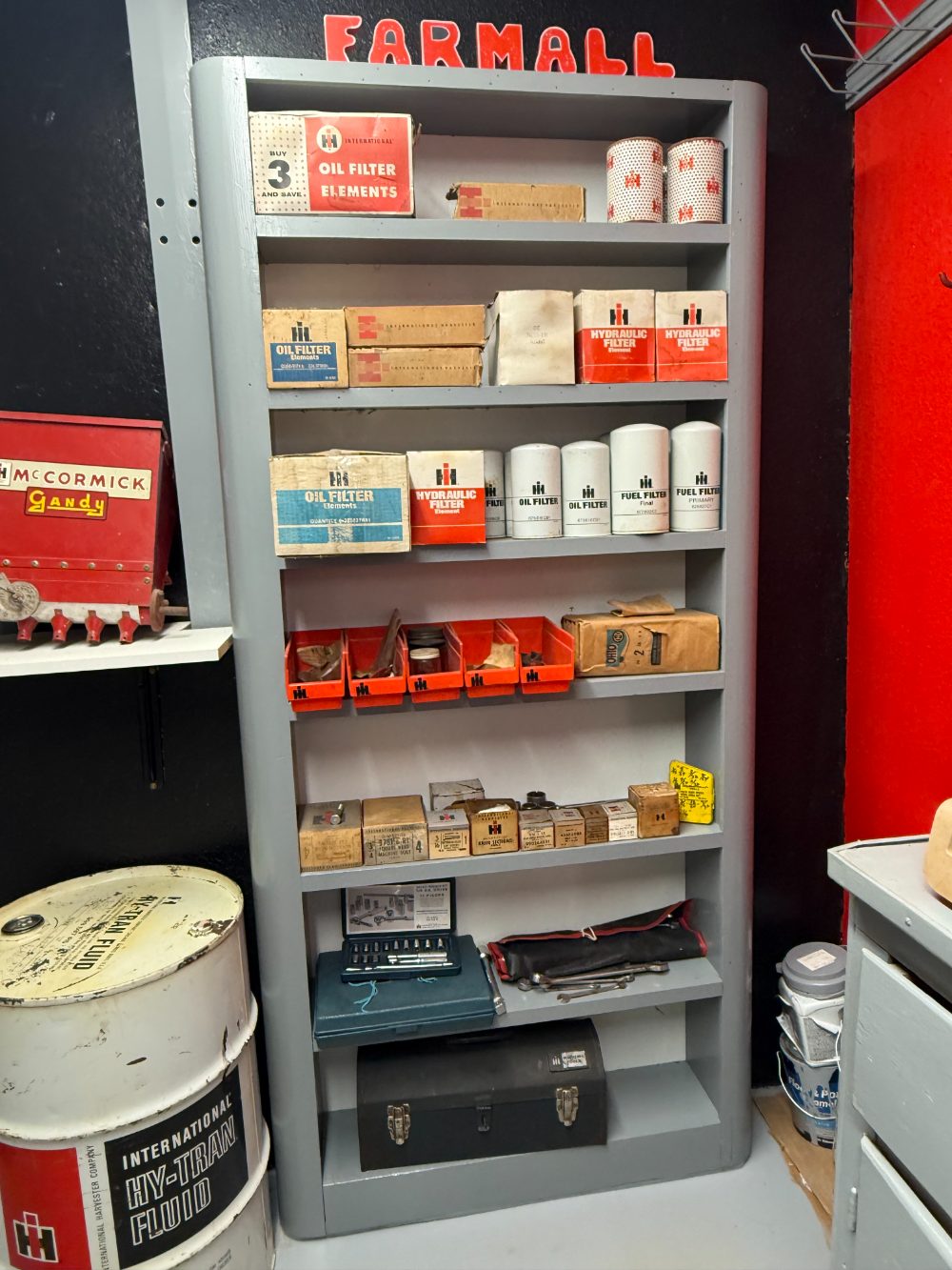 Shelves of original IH oil filters, hydraulic filters, and dealer parts packaging